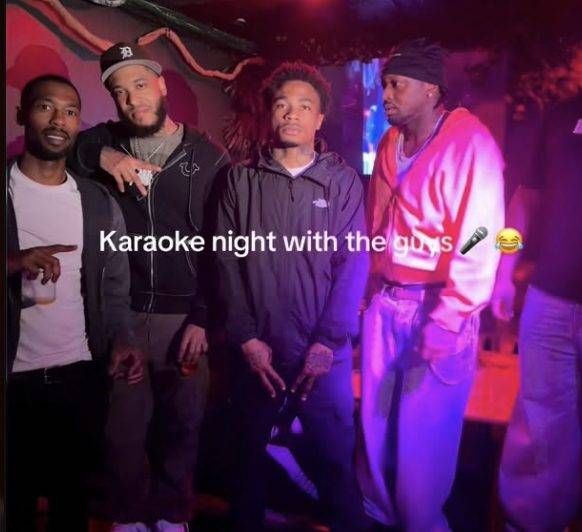 Social post still of four friends at a karaoke night in a dimly lit bar, captioned “Karaoke night with the guys”.